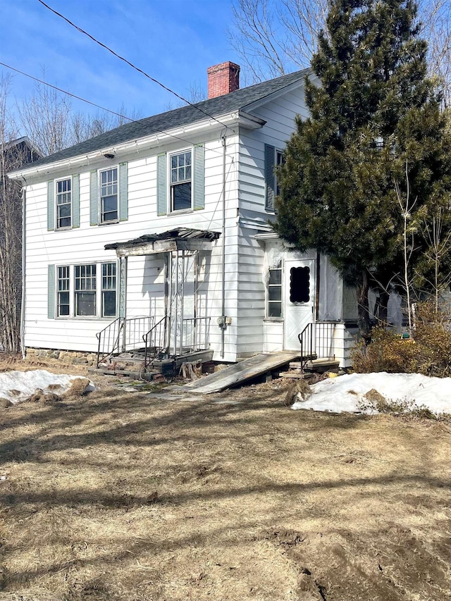 colonial home featuring a chimney