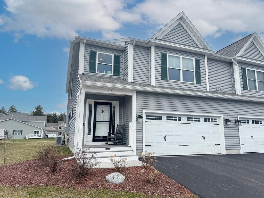 townhome / multi-family property with a garage and driveway