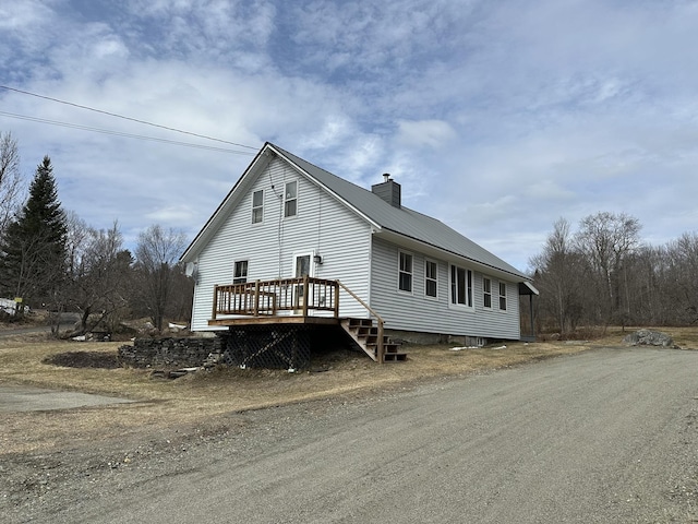 107 Ainsworth Rd, Woodbury, VT 05681 - view of front facade featuring a chimney, a deck, and metal roof