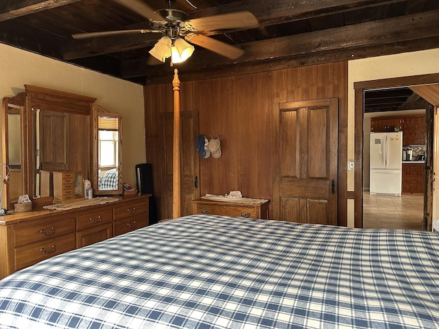 107 Ainsworth Rd, Woodbury, VT 05681 - bedroom with freestanding refrigerator, beam ceiling, wood ceiling, wooden walls, and tile patterned flooring