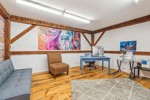 sitting room with hardwood / wood-style flooring and a textured ceiling