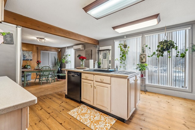 kitchen with black dishwasher, freestanding refrigerator, a wall mounted air conditioner, and light wood-style floors