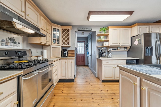 kitchen with stainless steel appliances, light wood finished floors, light countertops, and open shelves