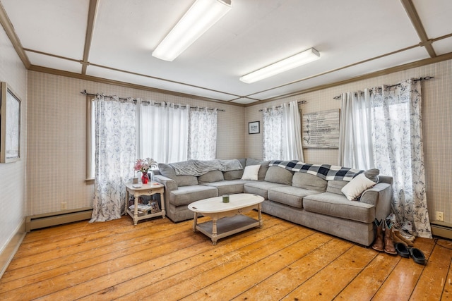 living room featuring a baseboard radiator, hardwood / wood-style floors, and wallpapered walls