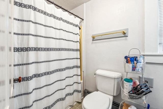bathroom featuring baseboard heating and toilet