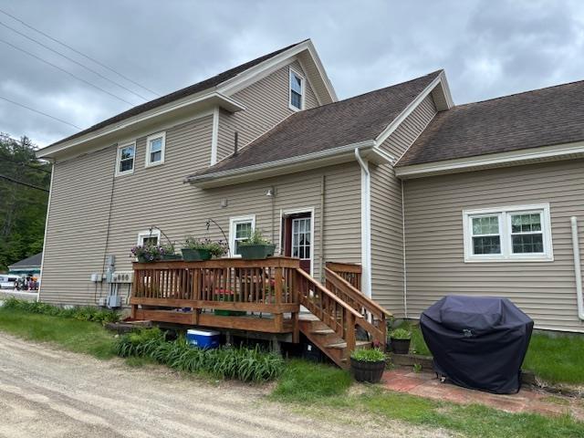 837 Lake St, Bristol, NH 03222 - back of property with a deck and roof with shingles