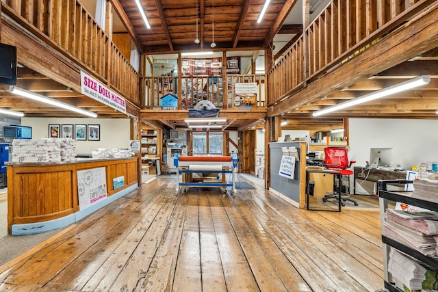 interior space with a high ceiling and hardwood / wood-style flooring