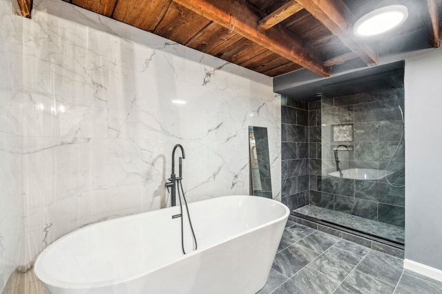 full bathroom with walk in shower, a freestanding tub, wood ceiling, beam ceiling, and marble finish floor