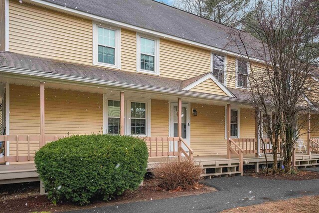 114 Winterwood Dr Unit 114, Londonderry, NH 03053 - view of property featuring covered porch and roof with shingles
