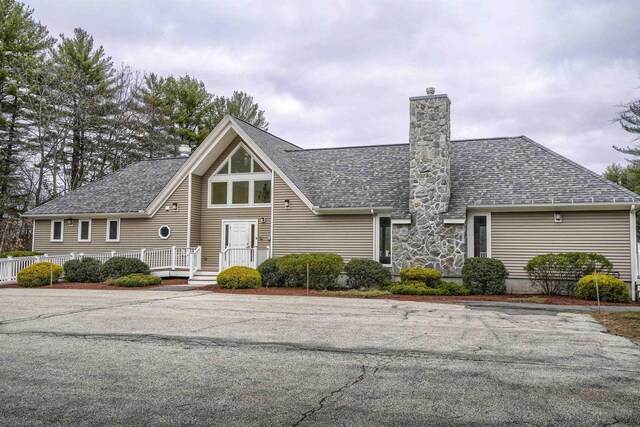 114 Winterwood Dr Unit 114, Londonderry, NH 03053 - view of front of property featuring roof with shingles and a chimney