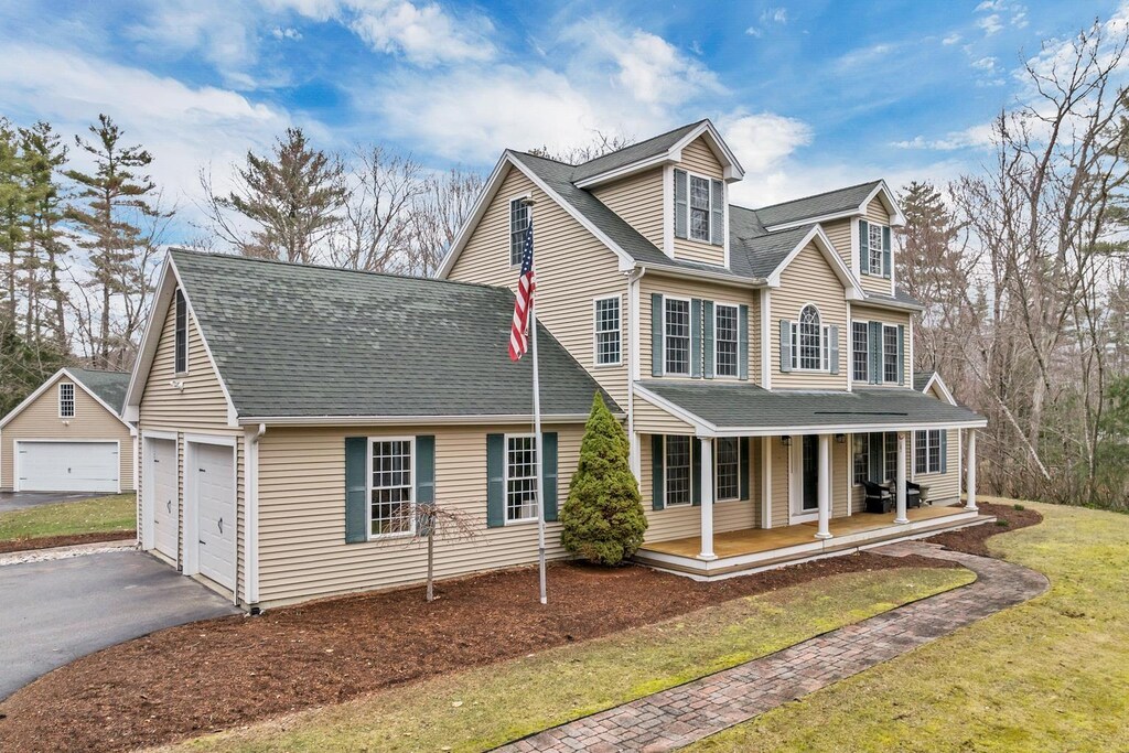 9 Carter Way, Strafford, NH 03884 - view of front of property with driveway, a front yard, a garage, a shingled roof, and covered porch