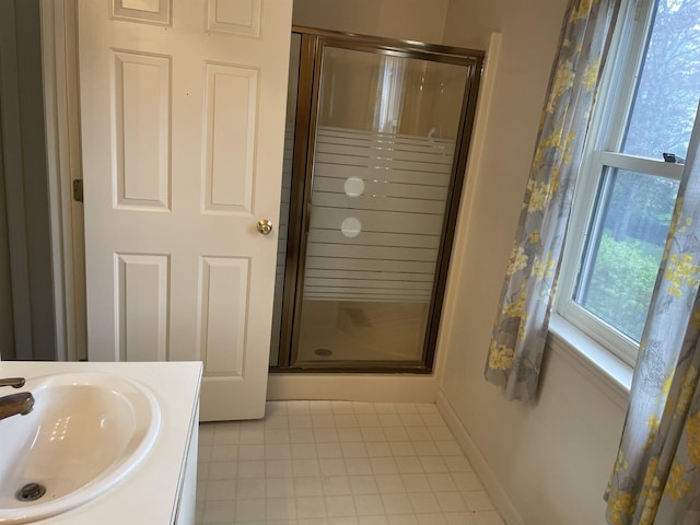 full bath with a stall shower, tile patterned floors, and vanity