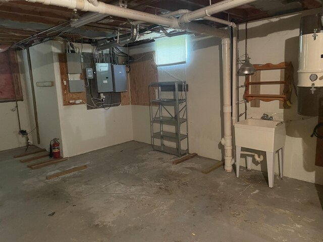 unfinished below grade area with electric panel and a sink