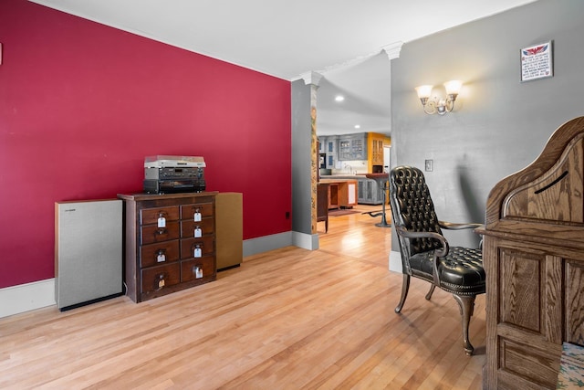 office space with a notable chandelier, baseboards, and wood finished floors