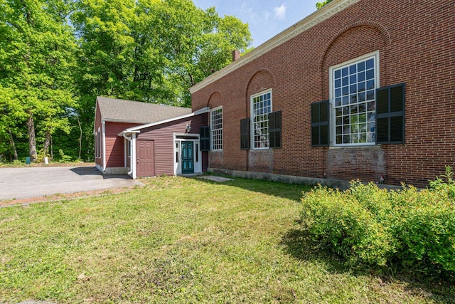 view of front of home with a front yard and brick siding
