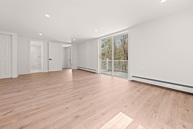 unfurnished living room with light wood-style flooring, a baseboard heating unit, and recessed lighting