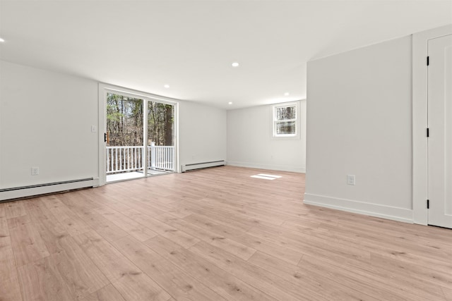 unfurnished room featuring baseboard heating, a baseboard radiator, baseboards, and light wood-style flooring
