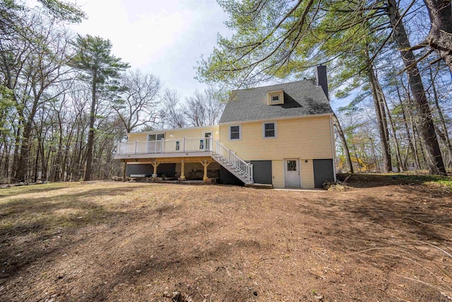 rear view of house featuring a chimney, a wooden deck, and stairway