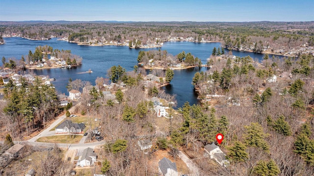 aerial view featuring a forest view and a water view