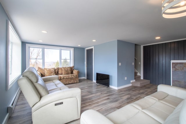 849 Mount Bess Rd, Charleston, VT 05872 - living area with a baseboard heating unit, recessed lighting, a fireplace, stairs, and wood finished floors