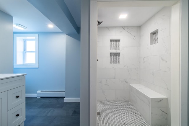 849 Mount Bess Rd, Charleston, VT 05872 - full bathroom featuring baseboard heating, tiled shower, vanity, and baseboards