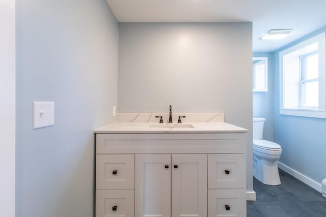 849 Mount Bess Rd, Charleston, VT 05872 - half bathroom featuring vanity, baseboards, and toilet