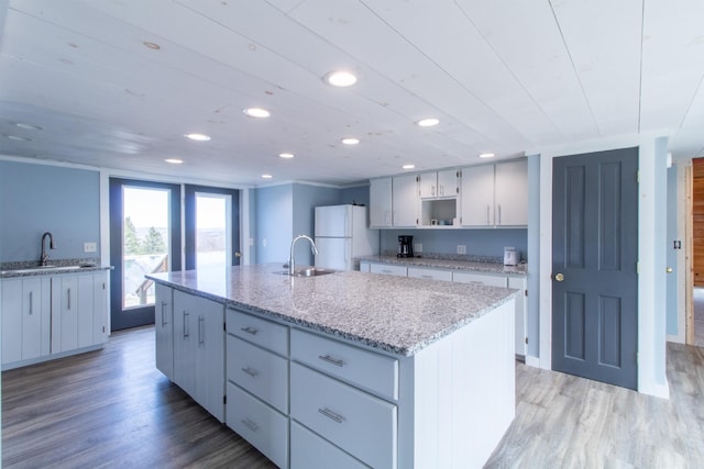 849 Mount Bess Rd, Charleston, VT 05872 - kitchen with light wood finished floors, freestanding refrigerator, and a sink