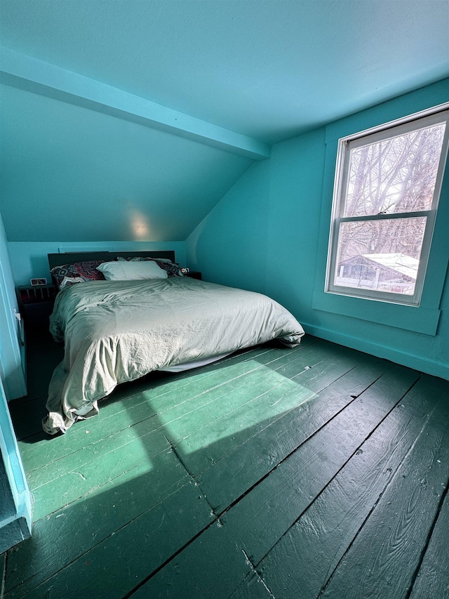 bedroom with wood-type flooring and lofted ceiling with beams