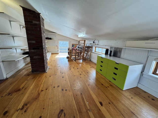 additional living space with wood-type flooring and lofted ceiling
