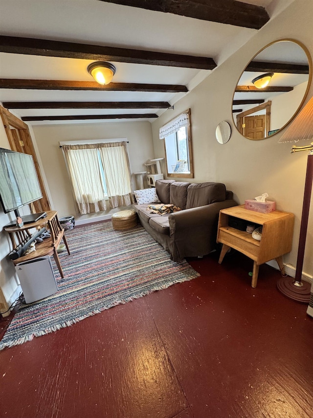 living area featuring beamed ceiling and wood finished floors