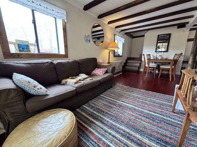 living room with wood finished floors, baseboards, beam ceiling, and stairway