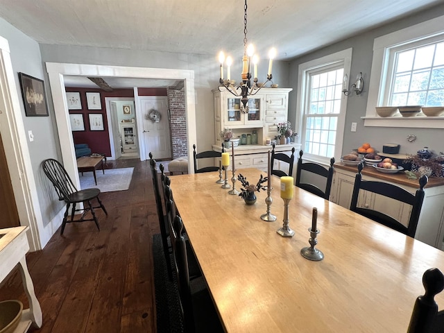 dining room with a chandelier and dark wood-style flooring