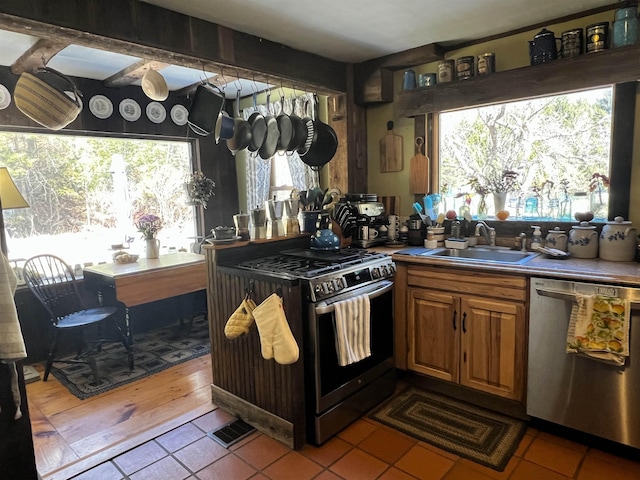 kitchen featuring a sink, visible vents, brown cabinetry, and appliances with stainless steel finishes