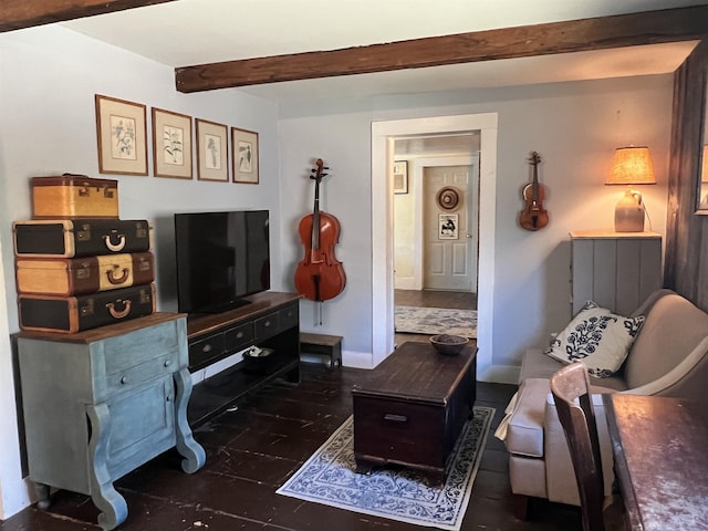 living room featuring baseboards and beamed ceiling
