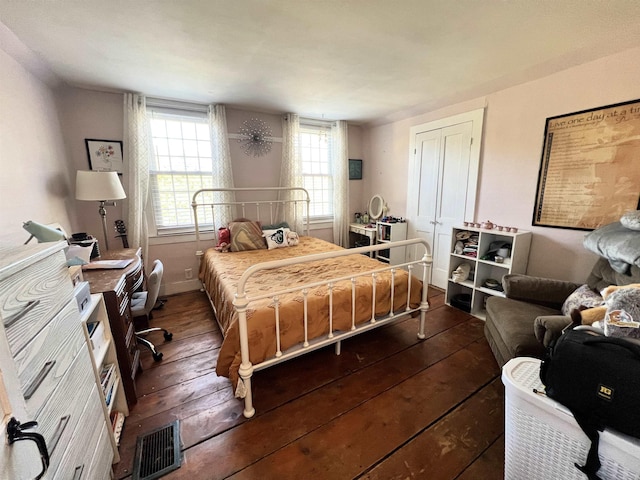 bedroom featuring dark wood-style flooring and visible vents