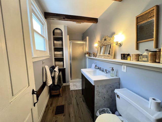 bathroom featuring vanity, toilet, a shower stall, visible vents, and wood finished floors