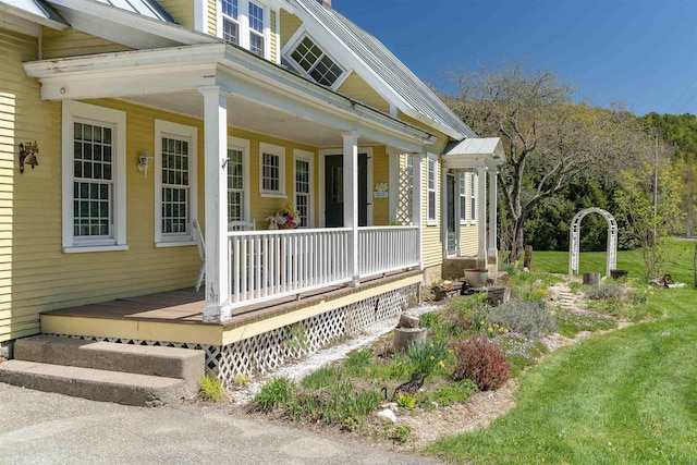 view of exterior entry with a porch