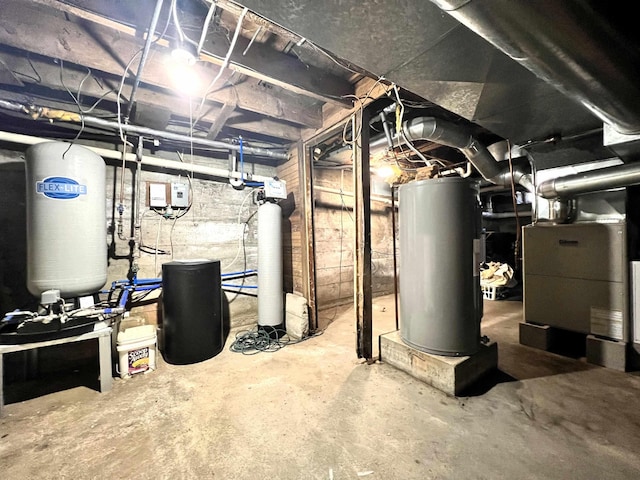 unfinished below grade area featuring water heater and heating unit