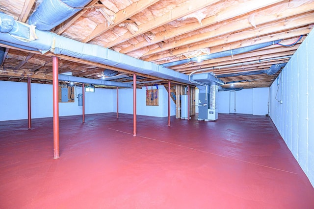 unfinished basement featuring gas water heater, heating unit, and electric panel