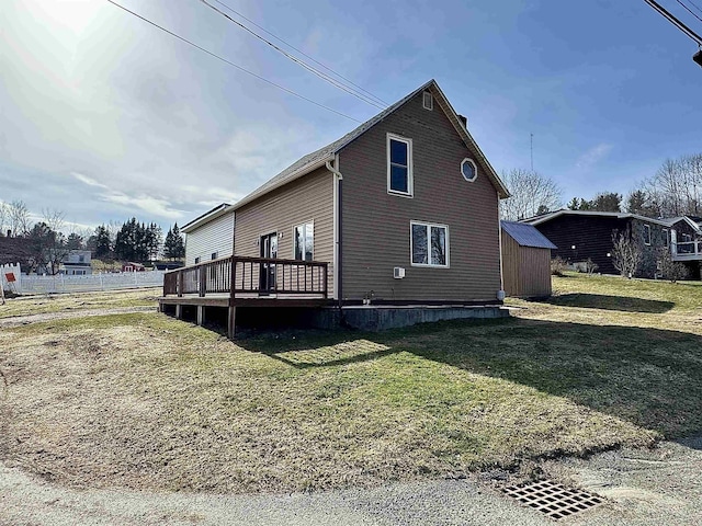 view of home's exterior featuring a yard and a wooden deck