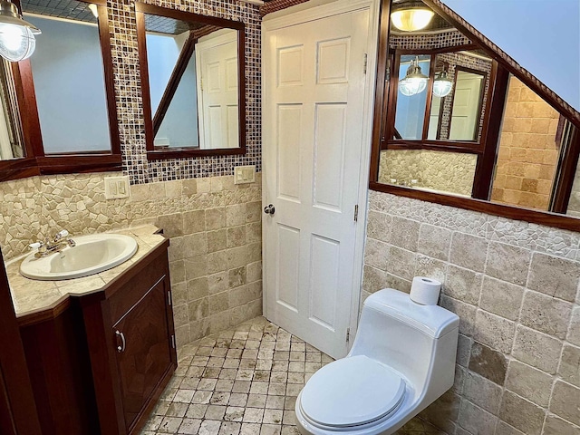 half bathroom with toilet, tile walls, and vanity