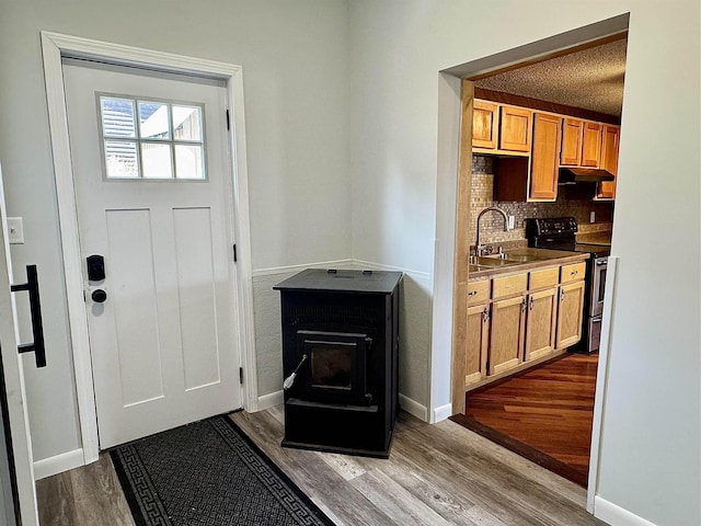 interior space with a sink, baseboards, and dark wood-style floors