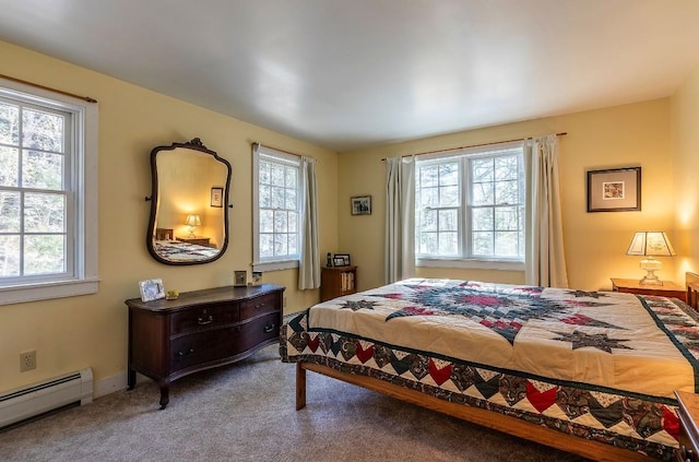 bedroom featuring carpet, baseboard heating, and multiple windows