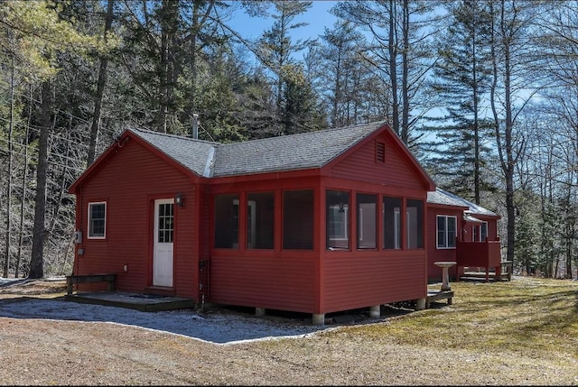 view of home's exterior with a shingled roof