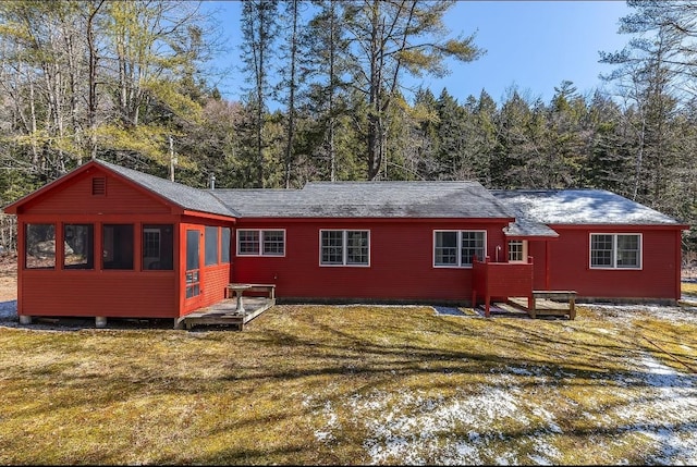 rear view of property with a yard