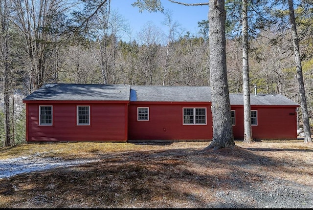 view of side of property featuring a forest view