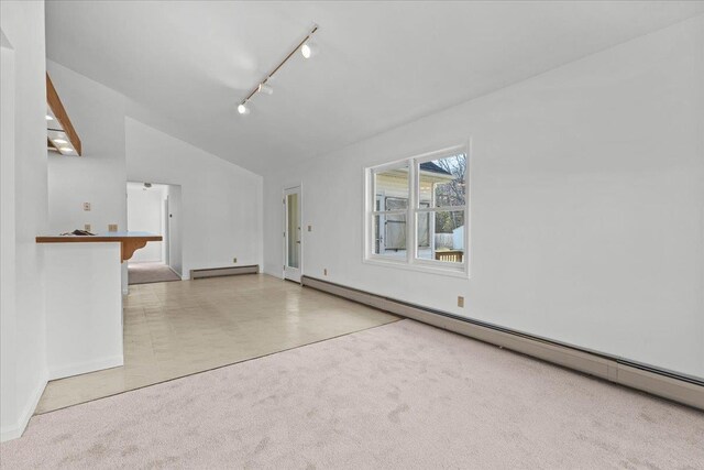1 Pine Grove Ter, Winooski, VT 05404 - spare room with track lighting, a baseboard radiator, baseboard heating, carpet flooring, and lofted ceiling