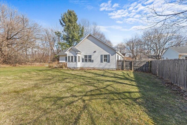 1 Pine Grove Ter, Winooski, VT 05404 - rear view of house with a fenced backyard and a lawn