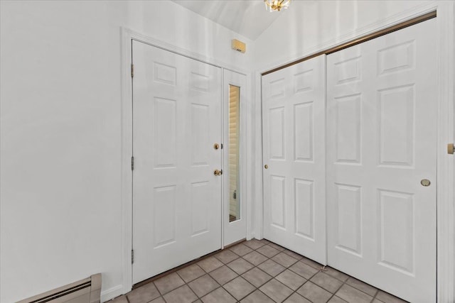 1 Pine Grove Ter, Winooski, VT 05404 - foyer with light tile patterned floors and a baseboard radiator