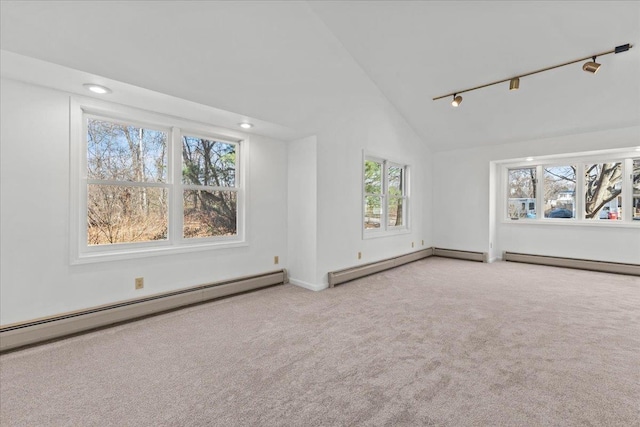 1 Pine Grove Ter, Winooski, VT 05404 - unfurnished living room with rail lighting, a baseboard radiator, vaulted ceiling, and a healthy amount of sunlight
